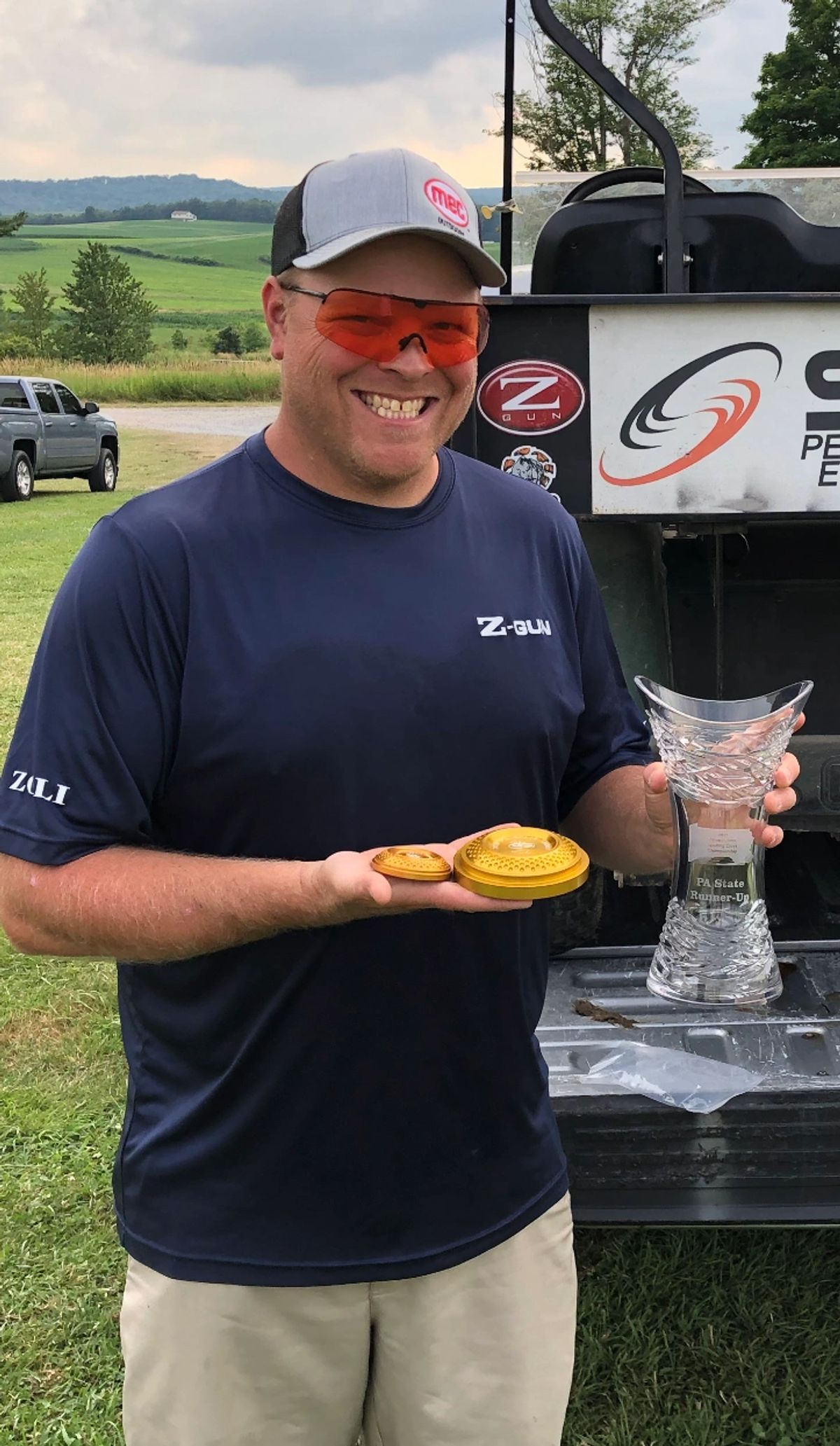 Jared Rumer holding PA State trophy and gold targets