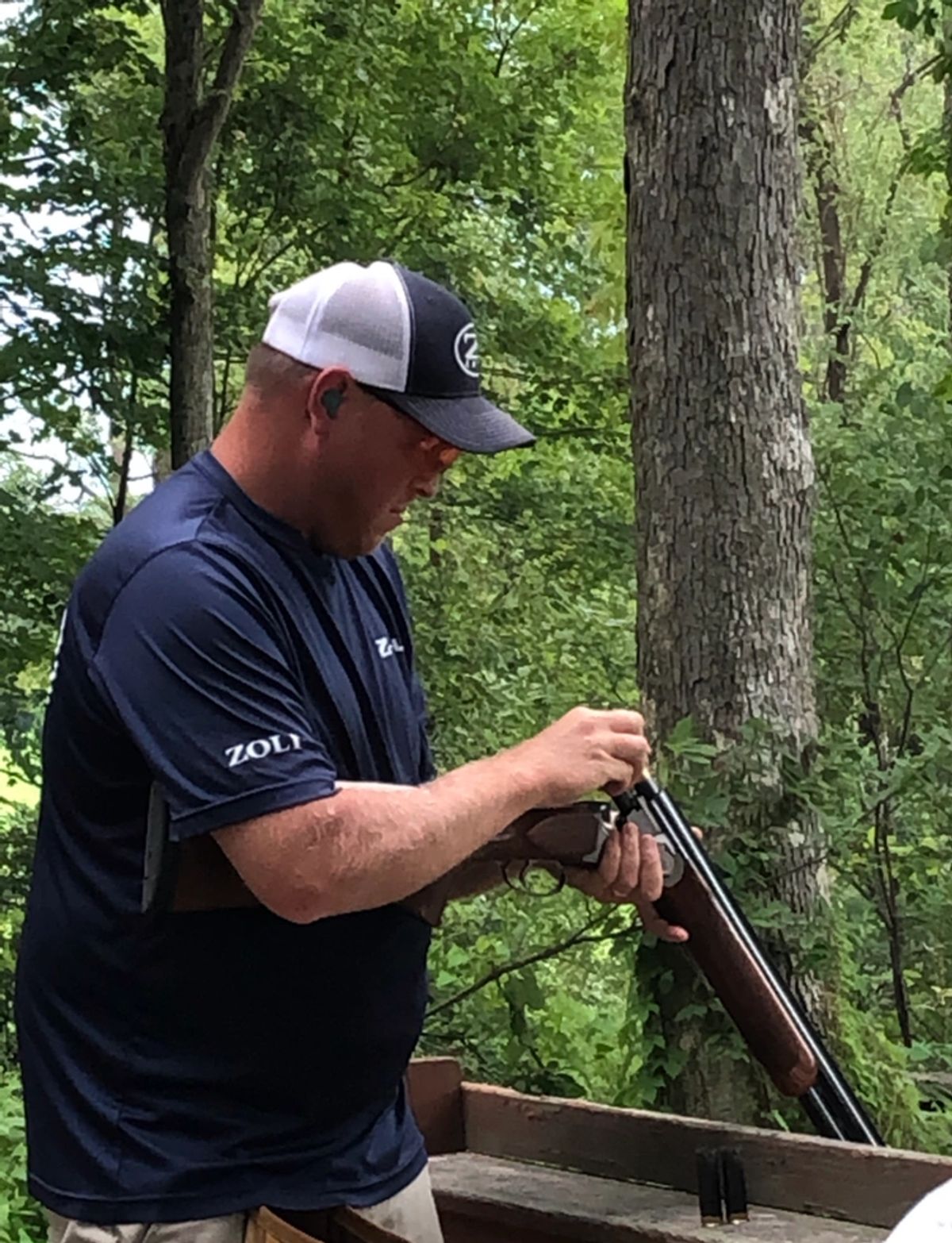 Jared Rumer preparing over-under shotgun at Northeast Clay Sports